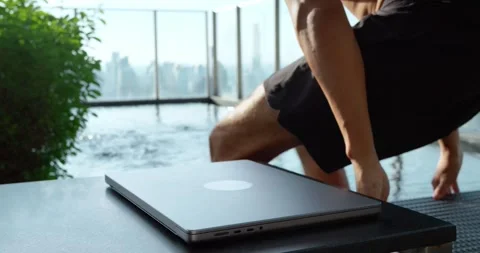 Man closes laptop heads pool against cityscape. Technology, symbolizing work Stock Footage 263178684