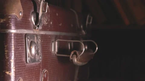 The man closes an old battered brown suitcase. Stock Footage 137738357