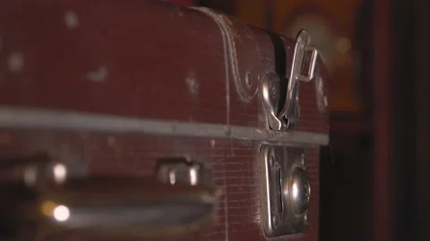 The man closes an old battered brown suitcase. Stock Footage 137738422