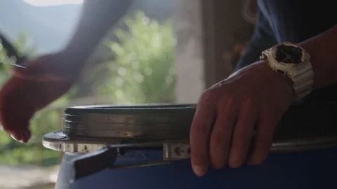 Man closes a plastic barrel. Stockbeeldmateriaal 76735719