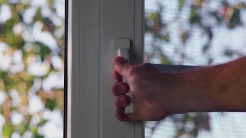 A man closes a plastic window in the kitchen Stock Footage 247333744