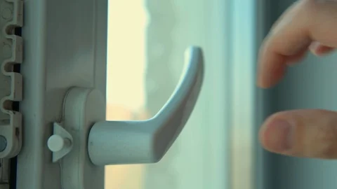 Man closes the window. Plastic glass packet Stock Footage 129610306