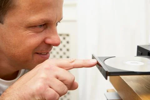 Man Closing DVD Player With Finger Stock Photos