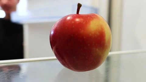 Man closing empty fridge to look for food, in the fridge there is an apple Stock Footage 297474166