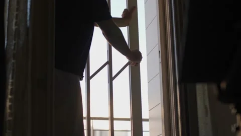 Man Closing a Grating inside the House-slow motion Video stock 139696700