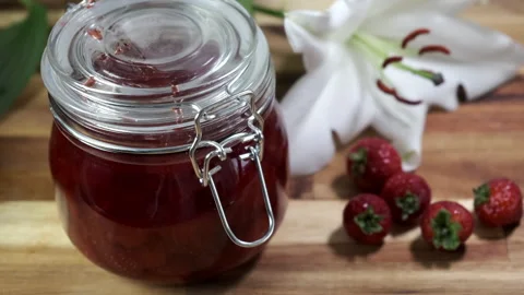 Man closing homemade strawberry jelly/ jam jar. 4k 60fps Stock Footage