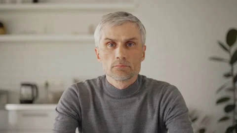 Man closing laptop and looking at camera at home Stock Footage 133530499