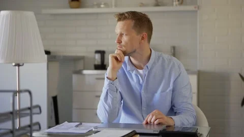 Man closing laptop and thinking at home Stock Footage 133951741