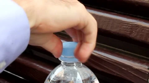 MAN CLOSING THE PLASTIC BOTTLE CUP OLD BENCH OF LVIV UKRAINE Video stock 65416668