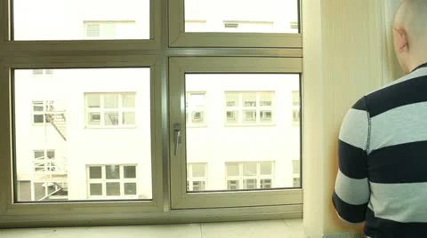 Man closing vertical blinds on the office window Stock Footage 22281586