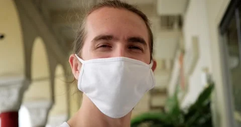 Man with cloth protective face mask smiling to camera. Stock-Footage 153999707