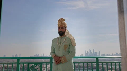 Man In Clothes In The Arabic Style. He Stands On The Balcony Of The Building Stock-Footage 153773536