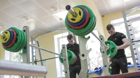 Man Coach Changes Weight on Barbell Video stock 61354944
