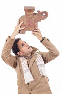 Man with the coat looking artifact Stock Photos