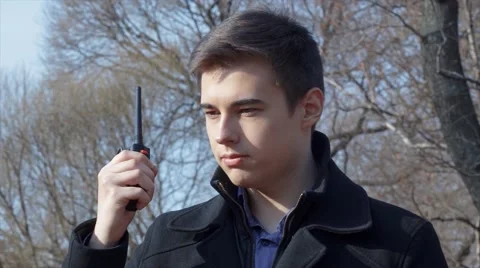 Man in coat talking walkie-talkie Stock Footage 61864778
