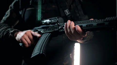 Man cocks a machine gun into a combat position Stock Footage 144069770