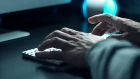 Man coder coding in computer language python on wireless computer keyboard Stock Footage 118802721