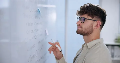 Man, coding and reading on whiteboard in office for review, system integration Stock Footage 280957056