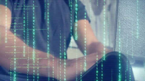 Man coding with digital binary code overlay. Cybersecurity and data Stock Footage 285825525