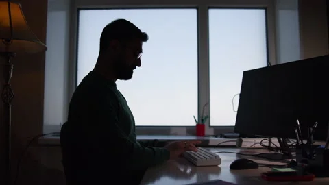 Man Coding Diligently. Focused Man Works At Desk. Concentrated Individual Types Stock Footage 345963618