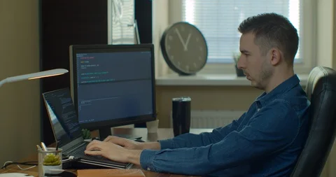 Man coding html and programming on screen Monitors, development web, developer. Stock Footage 129446803