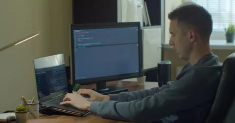 Man coding html and programming on screen Monitors, development web, developer. Stock Photos