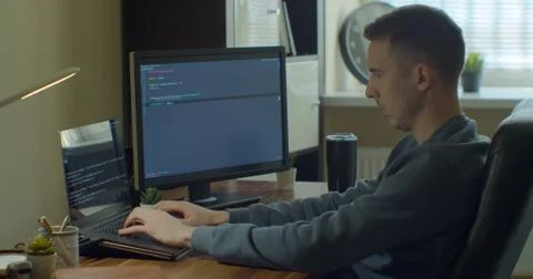 Man coding html and programming on screen Monitors, development web, developer. Stock Photos