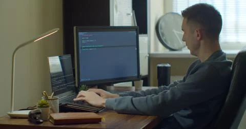 Man coding html and programming on screen Monitors, development web, developer. Stock Photos