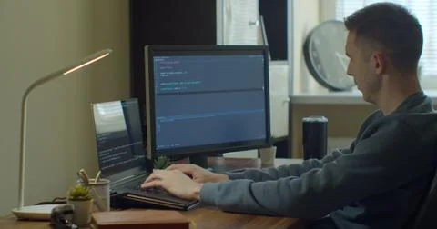 Man coding html and programming on screen Monitors, development web, developer. Stock Photos