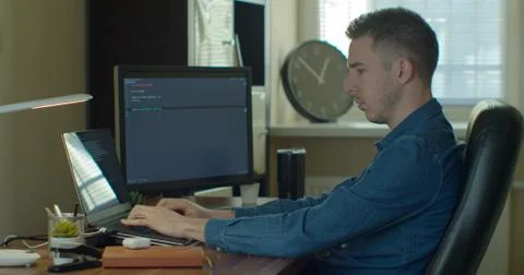 Man coding html and programming on screen Monitors, development web, developer. Stock Photos