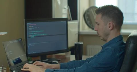 Man coding html and programming on screen Monitors, development web, developer. Stock Photos