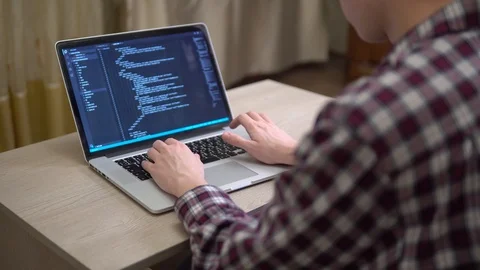 Man coding html over the shoulder developer working at home freelance script Stock Footage 127056776