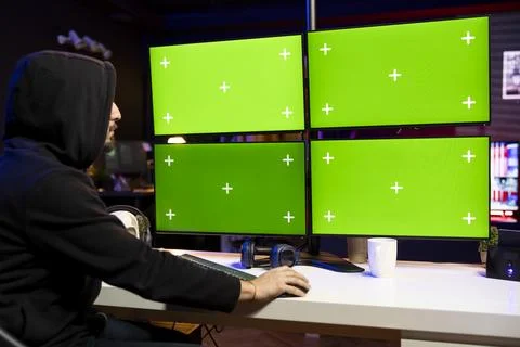 Man coding on isolated screen PC displays, creating stealth malware Stock Photos