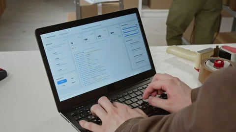 Man Coding on Laptop in E Commerce Logistics Warehouse Stock Footage 342591332