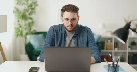 Man coding on laptop at home Video stock 189001388