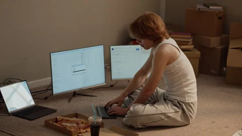 Man Coding with Multiple Computer Screens Sitting on Floor 库存影片 346602493