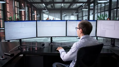 Man Coding On Multiple Screens Stock Footage 321955876