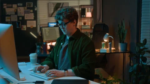 Man Coding Software on Computer Late at Night in Office Stock Footage 336718007