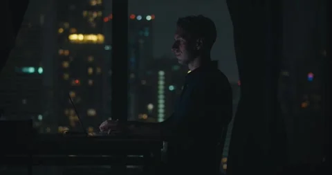 Man coding tirelessly at night, programmer refining complex software, programmer Stock Footage 312123167