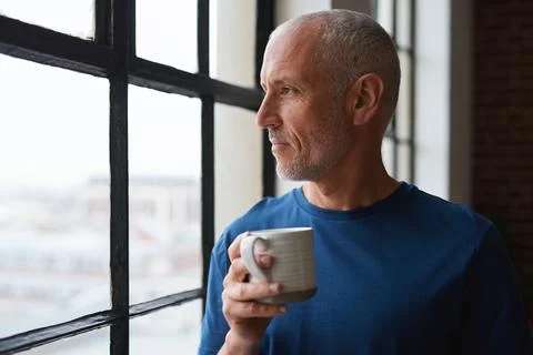 Man, coffee and thinking at window in home with reflection, memory or smile for  Stock Photos