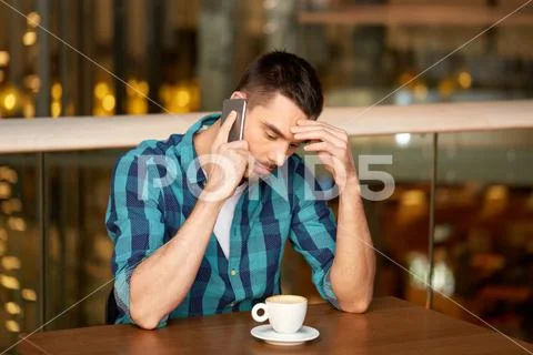 Man with coffee calling smartphone at restaurant Stock Photos