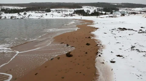 Man on a cold snowy winter beach Stock Footage 34092297