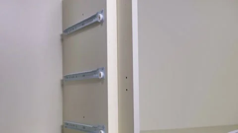 Man collects a drawer.panel with a guide roller Stock Footage 148416270