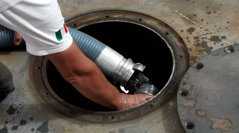 A man collects a gas sample while a tank is being filled. Stock Footage 67437328