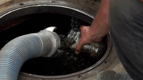 A man collects a gas sample while a tank is being filled, slow. Stock Footage 67438230