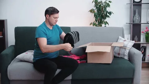 A man collects a parcel for those in need. Donation of warm clothes. Stock Footage 146539955