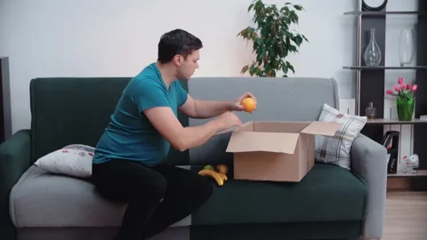 A man collects a parcel for those in need. Food donation. = Stock Footage 147668925