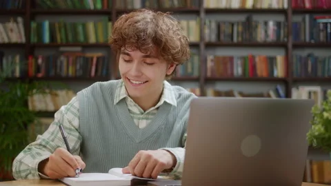 Man college student using laptop computer watching distance online learning Stock Footage 205796655