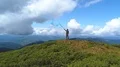 The man with a color smoke bomb standing on a picturesque mountain 4k or 4k+ Resolution