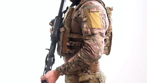 Man in combat camouflage with an automatic rifle in his hands rotates against Stock Footage 158013143